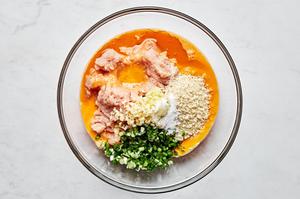 ground chicken, eggs, panko, ginger, garlic, green onions, salt, and sesame oil in a large glass bowl