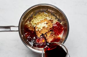 soy sauce, brown sugar, garlic, ginger, lime juice, sesame oil, and chili paste being cooked in a small skillet