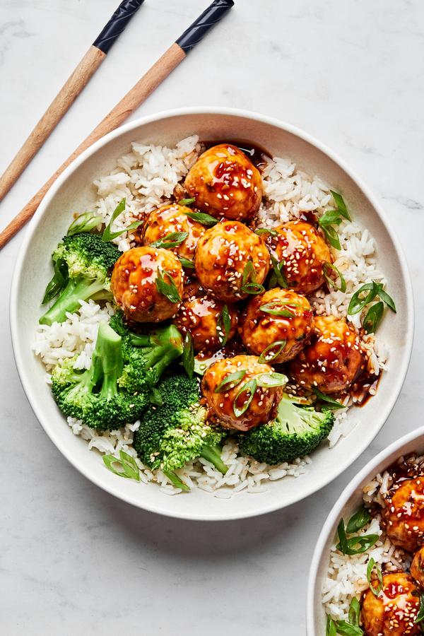 homemade teriyaki meatballs served over white rice with steamed broccoli next to chopsticks
