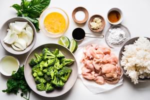 Ingredients laid out for basil Thai fried rice with chicken an onions and broccoli