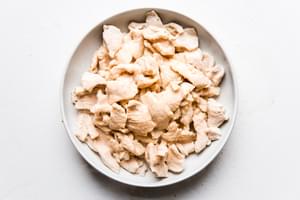 cooked pieces of thinly sliced chicken in a bowl