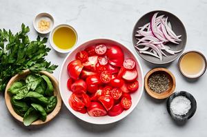 red onion, vinegar, garlic, tomatoes, olive oil, salt, parsley, basil, garlic, onion and vinegar in prep bowls