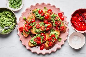 tomato and avocado bruschetta served on crusted garlic bread on a serving platter