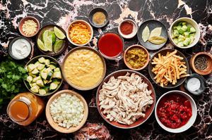 chicken, chicken stock, enchilada sauce, creamed corn, diced tomatoes, onion, zucchini, chiles and spices in prep bowls