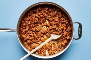 chorizo being cooked in a skillet to use for tostadas