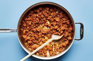 chorizo being cooked in a skillet to use for tostadas