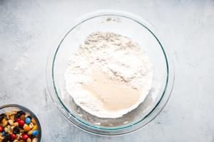 flour and milk in a bowl for trail mix pancakes