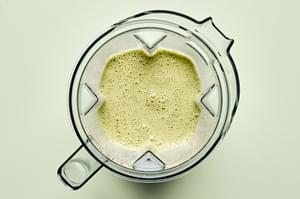 dressing in a blender made with coconut milk, curry paste, cilantro, mint, salt, macadamia nuts, lime juice & green onions.