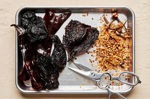 chiles cut open and deseeded on a baking sheet