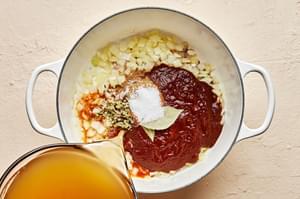 onions, blended chiles, stock, cumin, oregano, bay leaves and salt in a soup pot