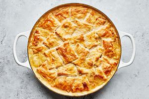 a homemade vegetable pot pie in a skillet made with butter, onion, carrot, celery, spices, green beans, peas and mushrooms