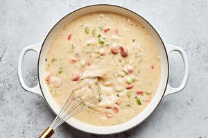 vegetable pot pie filling being whisked in a skillet
