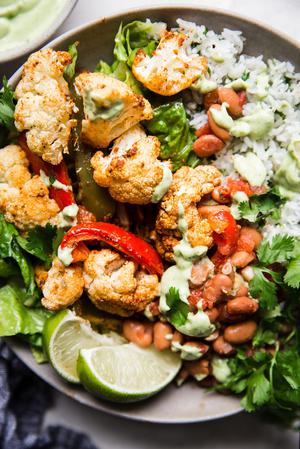vegetarian burrito bowl with cilantro rice, cauliflower limes and beans