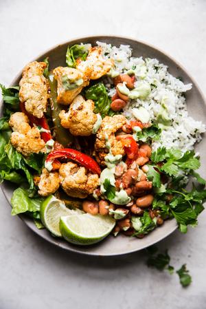 vegetarian burrito bowl with cilantro, lime, rice, beans and cauliflower