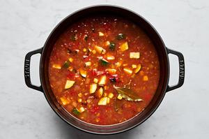 vegetarian tortilla soup made with vegetable stock, creamed corn, tomatoes, enchilada sauce, zucchini and spices in a pot