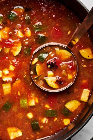 vegetarian tortilla soup made with vegetable stock, creamed corn, tomatoes, enchilada sauce, zucchini and spices in a pot