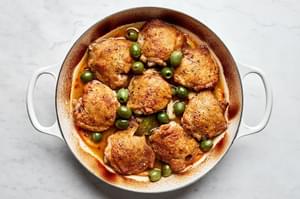 Vinegar chicken with oranges and olives, served with a rich sauce and garnished with red pepper flakes.
