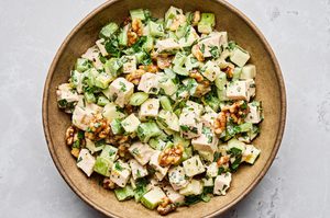 A fresh Waldorf salad made with crisp apples, celery, grapes, candied walnuts, and chicken tossed in a creamy dressing
