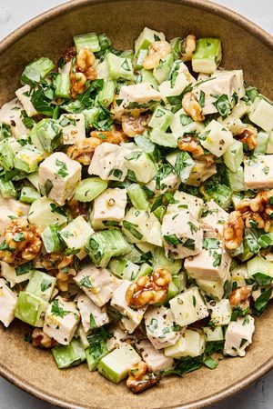 A fresh Waldorf salad made with crisp apples, celery, grapes, candied walnuts, and chicken tossed in a creamy dressing