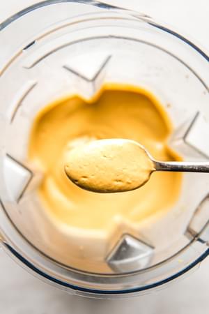 vegan cashew chipotle cream sauce in a blender with a spoonful