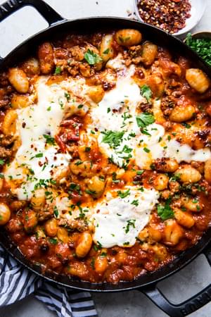 baked gnocchi with mozzarella cheese and marinara sauce in a large baking dish