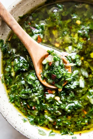 chimichurri sauce made with shallot, parsley, garlic, oregano, salt, pepper, olive oil, red wine vinegar & red pepper flakes