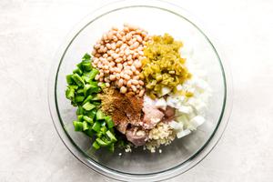 chicken, chicken stock, onions, green bell peppers, salsa, garlic and beans in a bowl to make green chicken chili soup
