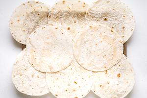 8 flour quesadillas on a baking sheet