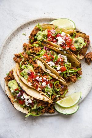 ground beef tacos with guacamole on a plate