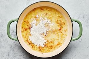 olive oil, garlic, butter and flour being cooked in a skillet