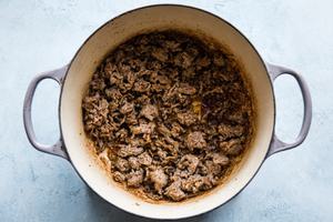 sausage being cooked in a soup pot
