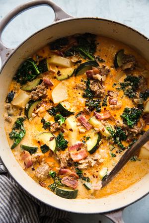 homemade zuppa toscana soup with in a soup pot sausage, potatoes and kale, parmesan cheese, and bacon